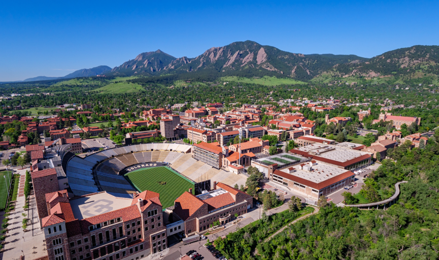 Aerial view of University of Colorado Boulder campus with mountains in background