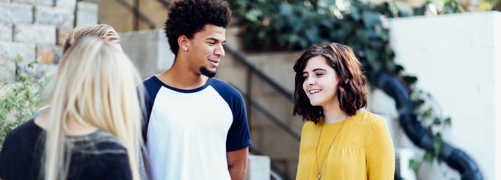 Three people standing outside and talking